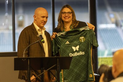 PORTLAND, OREGON - NOVEMBER 14: Heather Davis CEO of the Portland Timbers and Donnie McMillan Jr. CEO DaBella pose with the Timbers jersey at Providence Park on November 14, 2023 in Portland, Oregon. (Photo by Tom Hauck/Getty Images for DaBella)