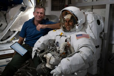 (Oct. 3, 2023) - Expedition 70 Commander Andreas Mogensen from ESA (European Space Agency) assists NASA astronaut Jasmin Moghbeli as she dons her spacesuit and tests its components in the Quest airlock in preparation for an upcoming International Space Station spacewalk. Credits: NASA