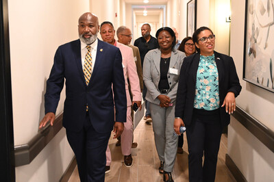 David A. Northern Sr. of Houston Housing Authority and Candace Valenzuela of HUD lead a group through 2100 Memorial after announcing the launch of two groundbreaking affordable housing programs, June 25, 2024. (Quincy Holmes)